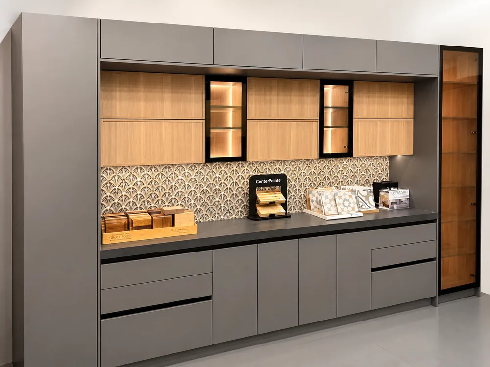 Cabinetry, patterned backsplash, and wood finish samples inside the Classic Floors showroom