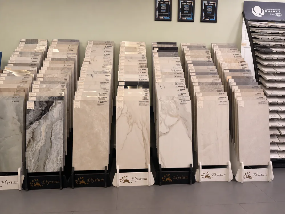 Rows of large-format tile and stone samples inside the Classic Floors showroom
