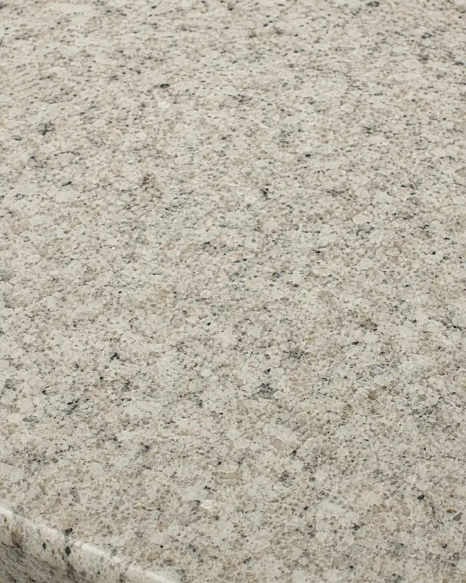Speckled granite countertop surface in quiet warm neutral tones