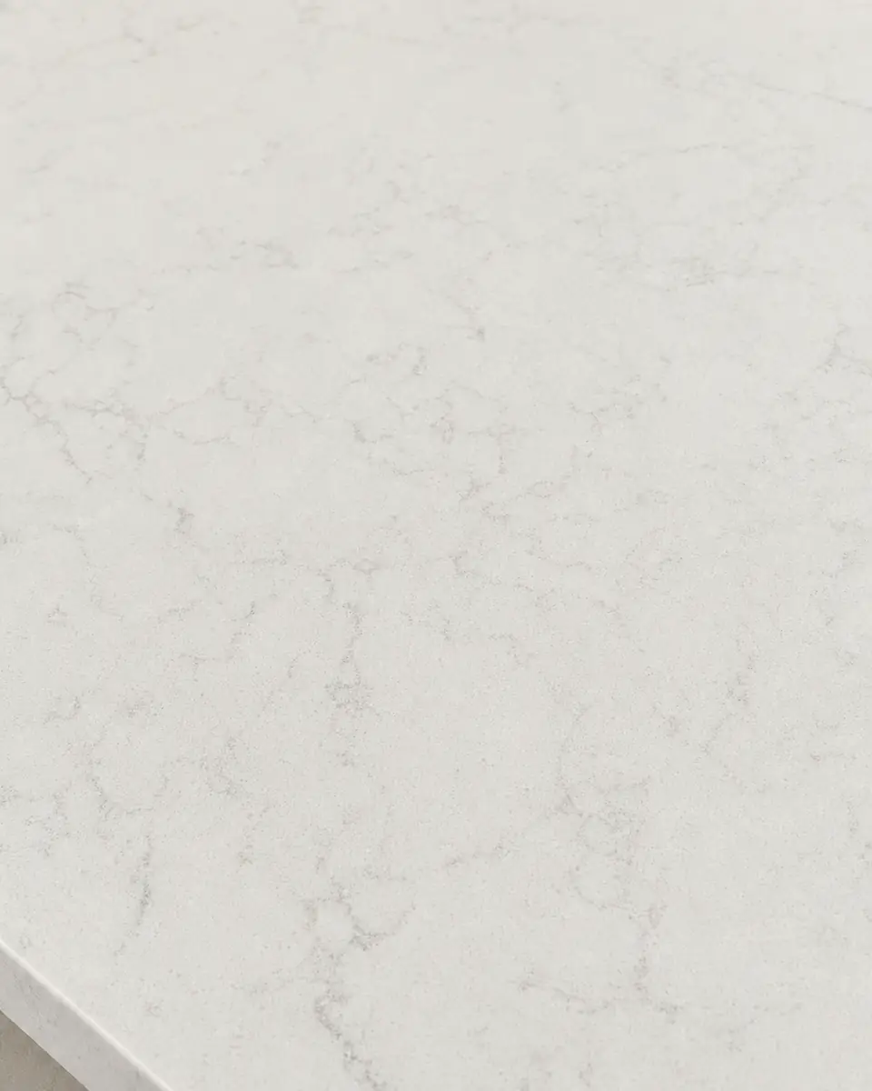 Engineered quartz countertop surface in warm white with soft consistent veining